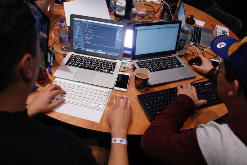 Attendees working on Apple Inc. laptop computers participate in the TechCrunch Disrupt London 2015 Hackathon. 