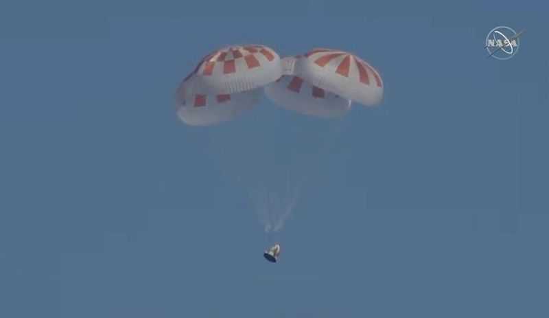 All four parachutes opened as intended, bringing Dragon to a soft landing in the Atlantic Ocean on Friday.