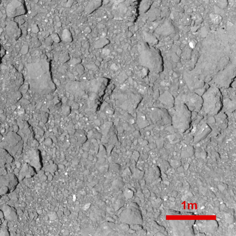 Greyscalle image of a dusty field of rocks.