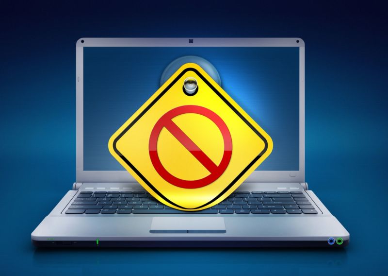 A laptop with a no-entry sign over its screen.
