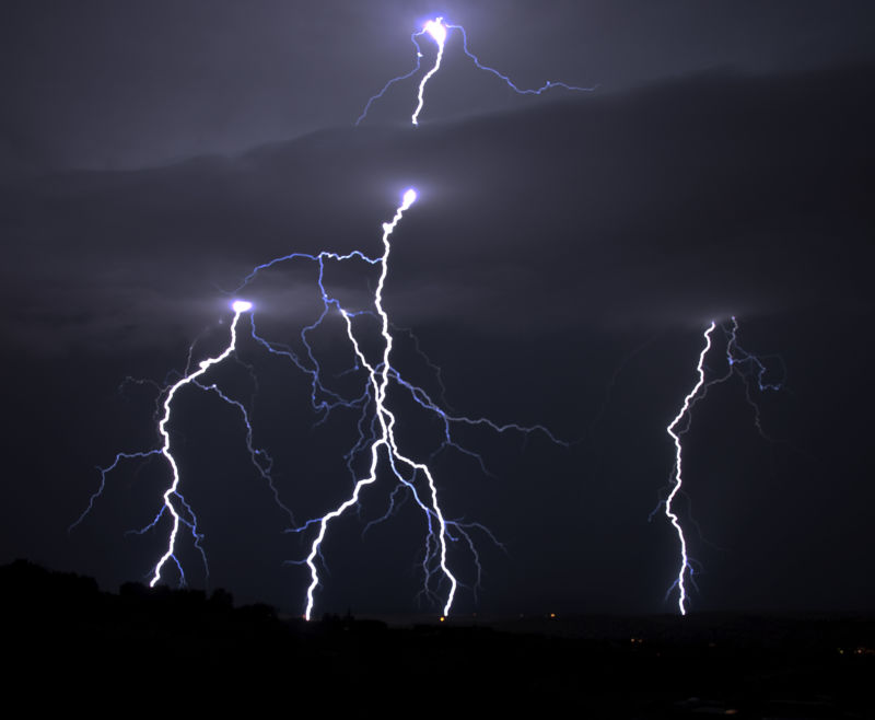 Lightning blazes in the night sky.