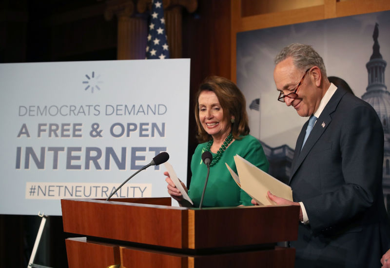 WASHINGTON, DC - MAY 16: Senate Democratic leader Charles Schumer (D-NY), with House Democratic leader Nancy Pelosi (D-CA) looking on, speaks at a press conference at the Capitol Building on May 16, 2018 in Washington, DC. The Senate voted and passed a Resolution of Disapproval to undo President Trump and FCC Chairman Ajit Pai's repeal of net neutrality rules. 