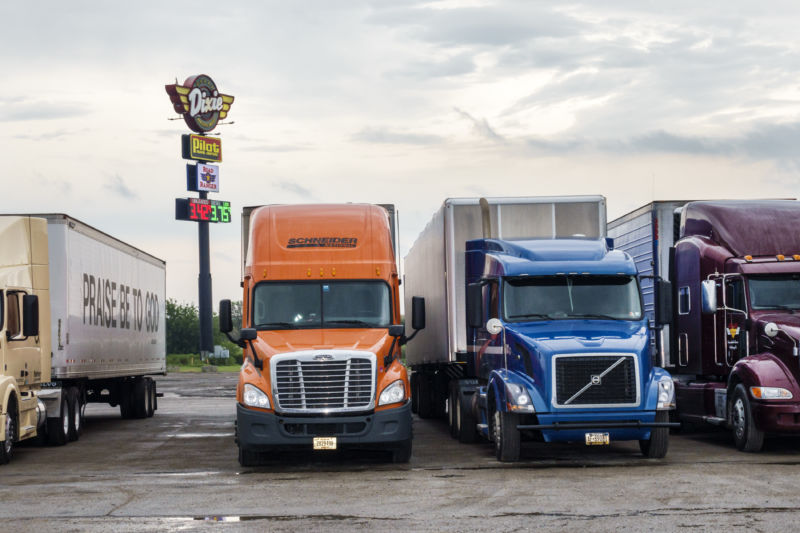 Trucks lined up at a truck stop.