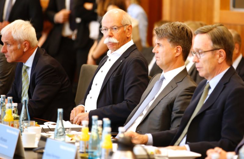 Four executives from the German automotive industry attend an event.