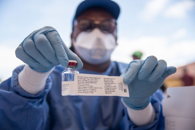 A nurse working with the World Health Organization (WHO) shows a bottle containing Ebola vaccine at the town hall of Mbandaka on May 21, 2018 during the launch of the Ebola vaccination campaign.