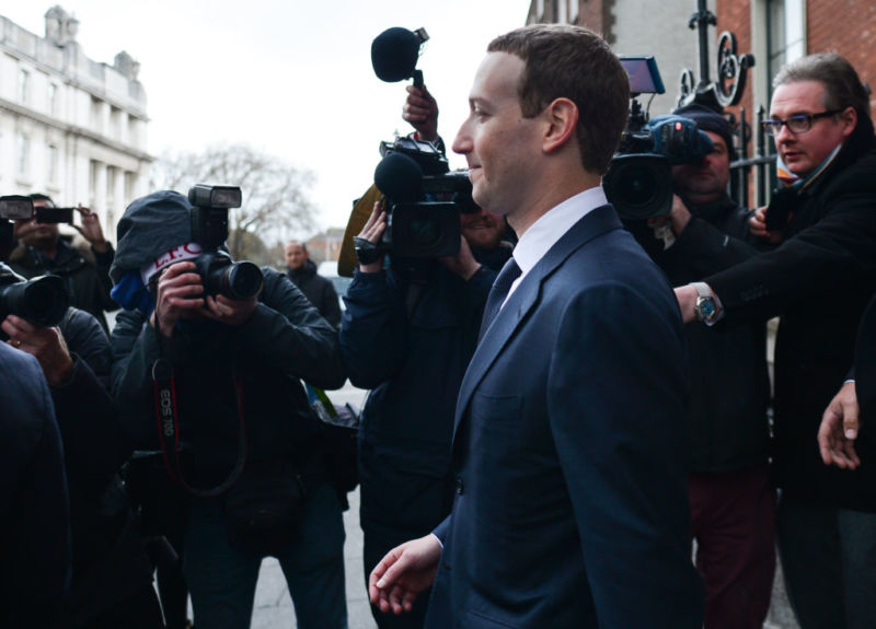 Facebook CEO Mark Zuckerberg in costume and photographed by several photographers as he leaves a hotel.