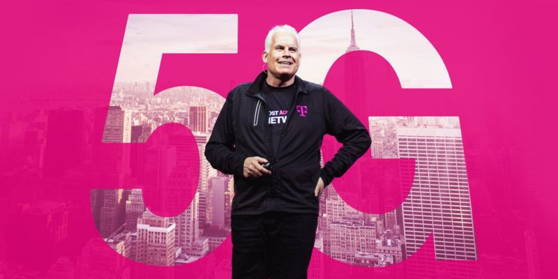 T-Mobile CTO Neville Ray stands in front of a backdrop that says, 