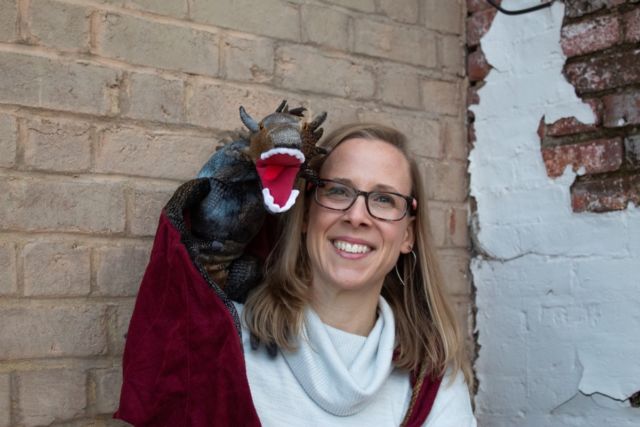 Physicist Rebecca Thompson poses with her own baby dragon.