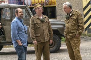 Author and two actors standing on the Chernobyl set.