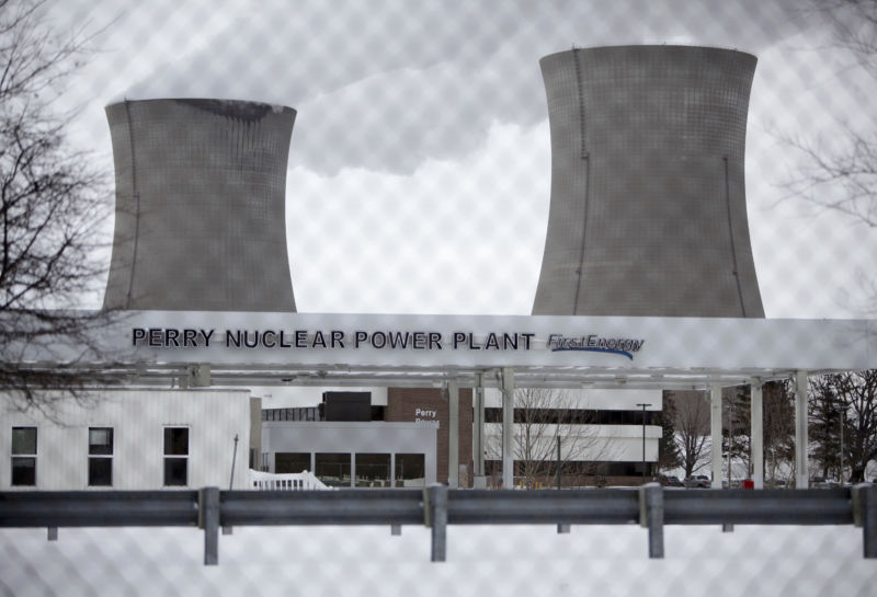 Cooling towers behind nuclear plant entrance.