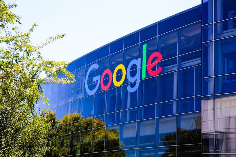 A large Google sign seen on a window of Google's headquarters.