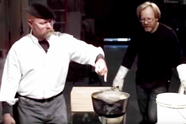 Adam Savage looks on as Jamie Hyneman dips a wetted finger into hot lead in a 2009 episode of <em>Mythbusters.</em> Thanks to the Leidenfrost effect, Jamie's finger was fine.