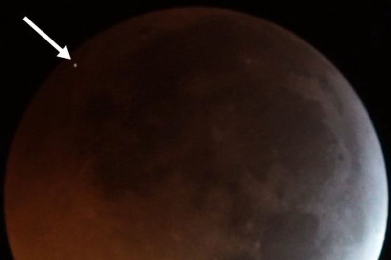 The flash from the impact of a meteoroid on the eclipsed Moon in early 2019, seen as the dot at top left.