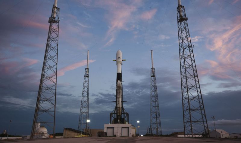 The Falcon 9 rocket, on the launchpad, with its Starlink cargo tucked into the payload fairing.