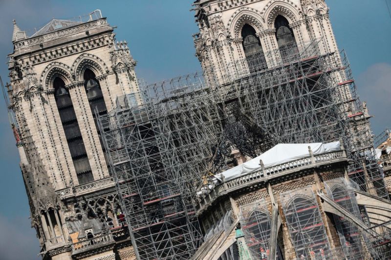 Protective tarps displayed on the roof of Notre-Dame de Paris cathedral, two weeks after a fire devastated it.