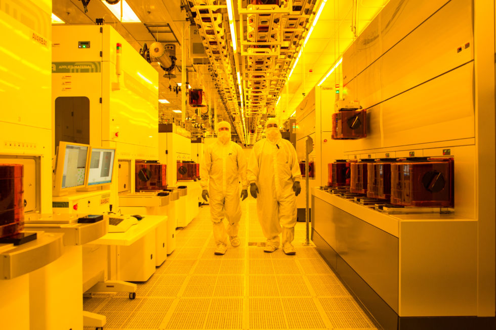 A significant portion of the Micron fab is bathed in yellow light to protect the light-sensitive coating on the wafers. Chips on the wafers are created using a photographic process. Each of the cameras, which are the machines on each side of the aisle, costs about $70 million.