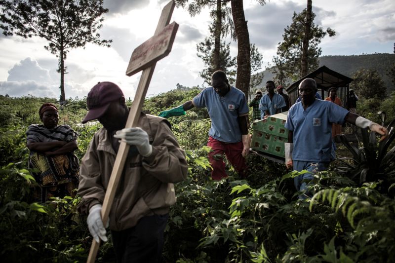 Health workers carry a coffin containing a victim of Ebola virus on May 16, 2019, in Butembo, DRC, a city at the epicenter of the Ebola crisis.