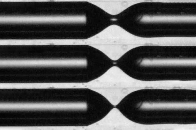 This series of images shows the process of "pinch-off" in which the air bubble (black) starts to separate off as it penetrates into a liquid environment (white) inside a narrow tube.