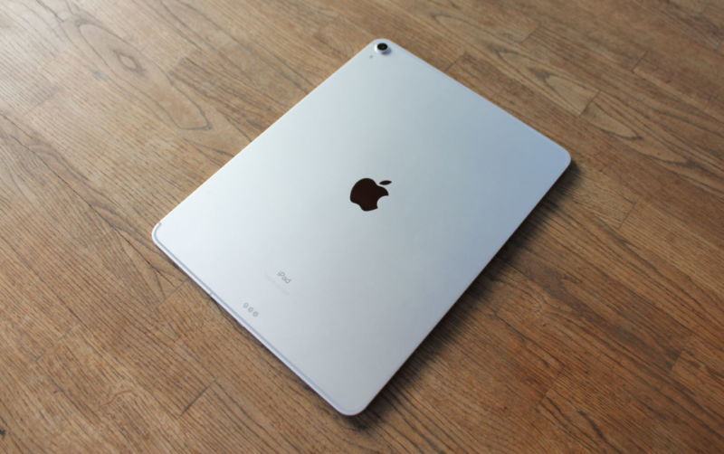 Apple-branded device sitting on a wooden surface.