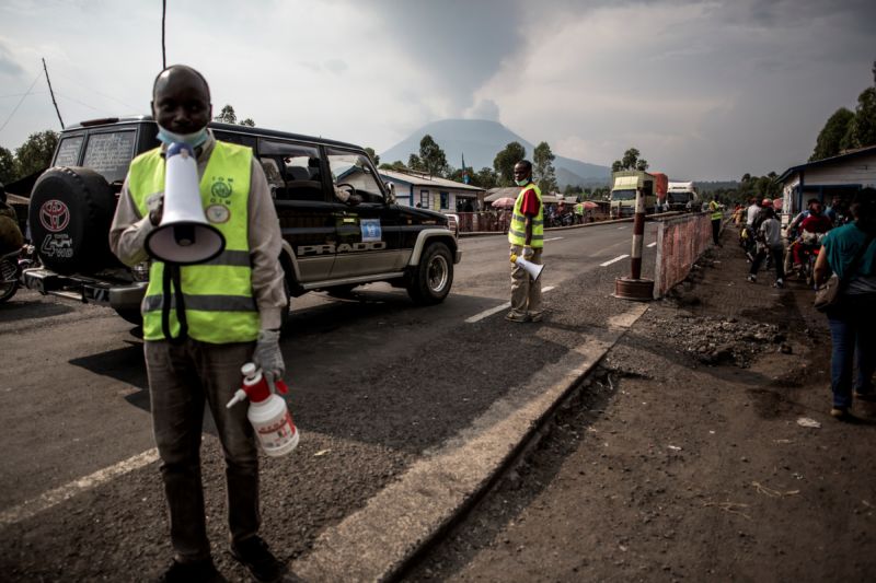 Health workers communicate information about Ebola at an Ebola screening station on the road between Butembo and Goma on July 16, 2019, in Goma, DRC.