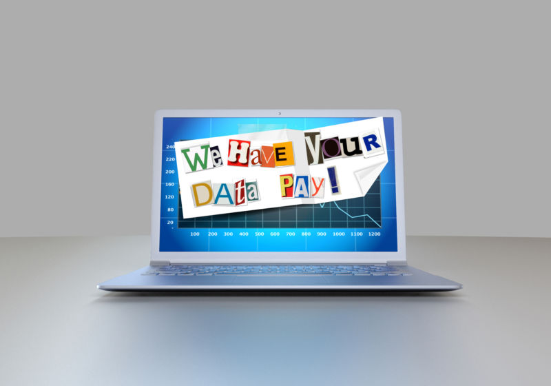 A ransom note displayed prominently on a‌ laptop screen.