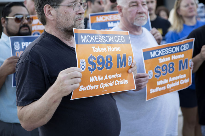 Members of the International Brotherhood of Teamsters hold signs while protesting during the McKesson Corp. annual meeting at the Irving-Las Colinas Chamber of Commerce in Irving, Texas, US, on Wednesday, July 26, 2017. 