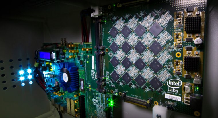 This is a picture of an Intel Nahuku board, which can contain 8 to 32 Loihi neuromorphic processing units, interfaced to an Intel Arria 10 FPGA development kit. Intel’s latest neuromorphic system, Pohoiki Beach, is made up of multiple Nahuku boards and contains 64 Loihi chips.