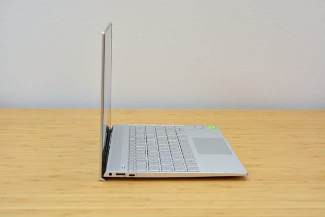 The HP Envy 13 laptop on a wooden table.