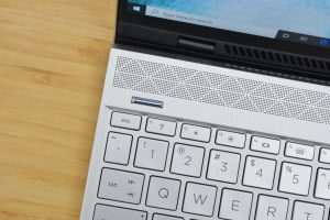 The HP Envy 13 laptop on a wooden table.