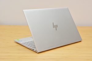 The HP Envy 13 laptop on a wooden table.
