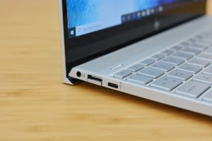 The HP Envy 13 laptop on a wooden table.