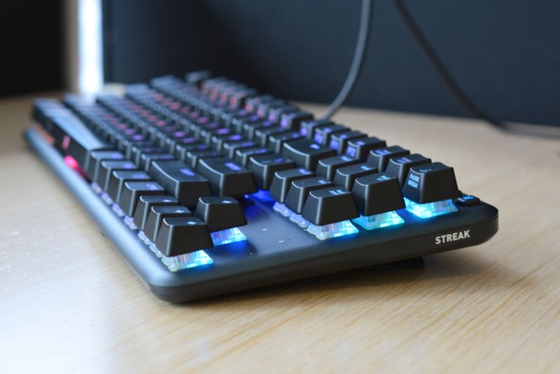 The Fnatic MiniStreak gaming keyboard on a wooden table.
