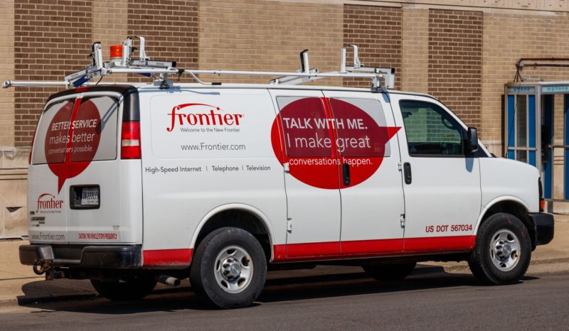 A Frontier Communications service van parked in front of a building.