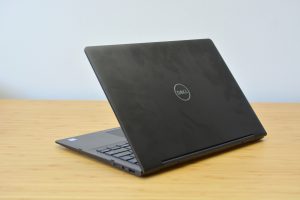 The Dell Inspiron 13 7000 Black Edition sitting on a wooden table.