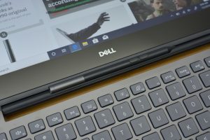 The Dell Inspiron 13 7000 Black Edition sitting on a wooden table.