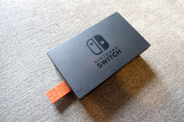 The 8Bitdo Wireless USB Adapter plugged into the USB port on the Switch dock.