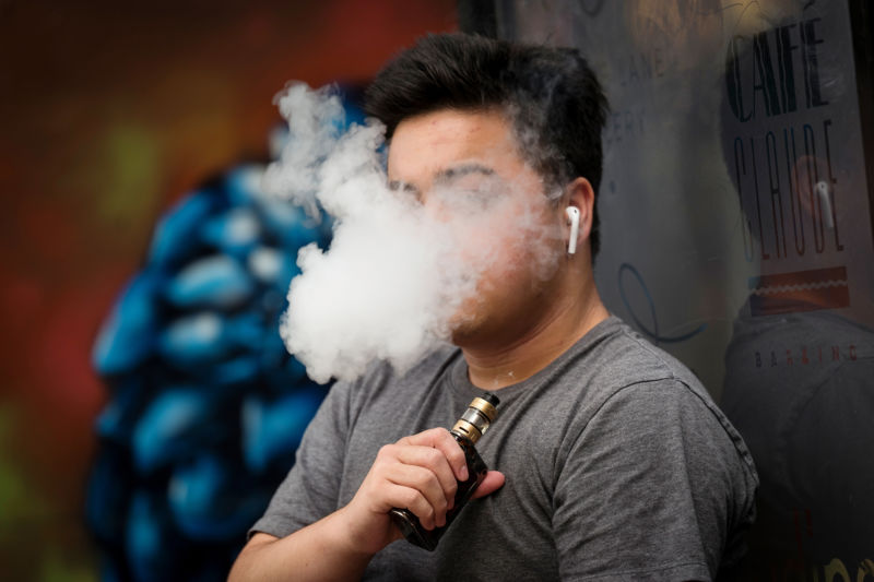 A person exhales vapor while using an electronic cigarette device in San Francisco, California, U.S., on Monday, June 24, 2019. 