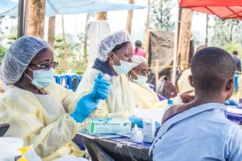 BUTEMBO, CONGO - JULY 27: A healthcare member inoculates a man for Ebola to take precautions against the disease in Butembo, Democratic Republic of the Congo.