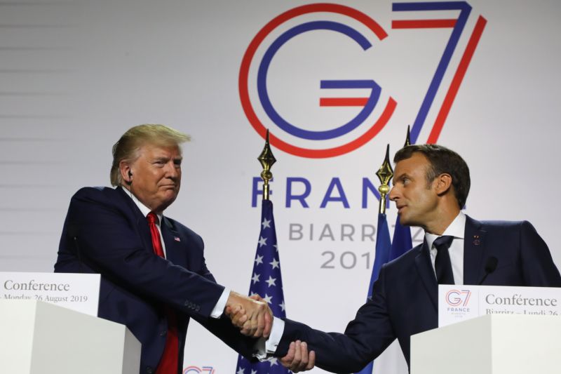 France's President Emmanuel Macron (R) and US President Donald Trump shake hands during a joint press conference in Biarritz, France, on August 26, 2019.