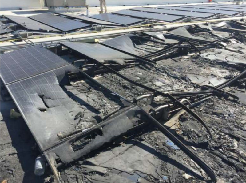 A photo from Walmart's lawsuit shows charred solar panels on top of a Walmart store.