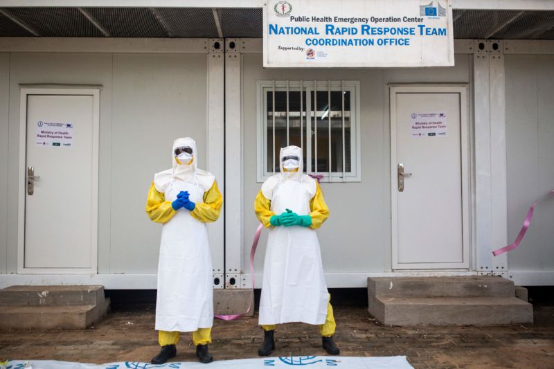 Staff from South Sudan's Health Ministry pose with protective suits during a drill for Ebola preparedness conducted by the World Health Organization (WHO).