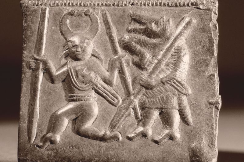 Sixth century Viking matrix used in the manufacture of helmet plaques, depicting Odin accompanied by a Berserker.