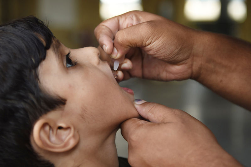 A Pakistani health worker administers polio vaccine drops to a child during a vaccination campaign in Karachi on December 10, 2018. Pakistan is one of only two countries in the world where polio remains endemic.