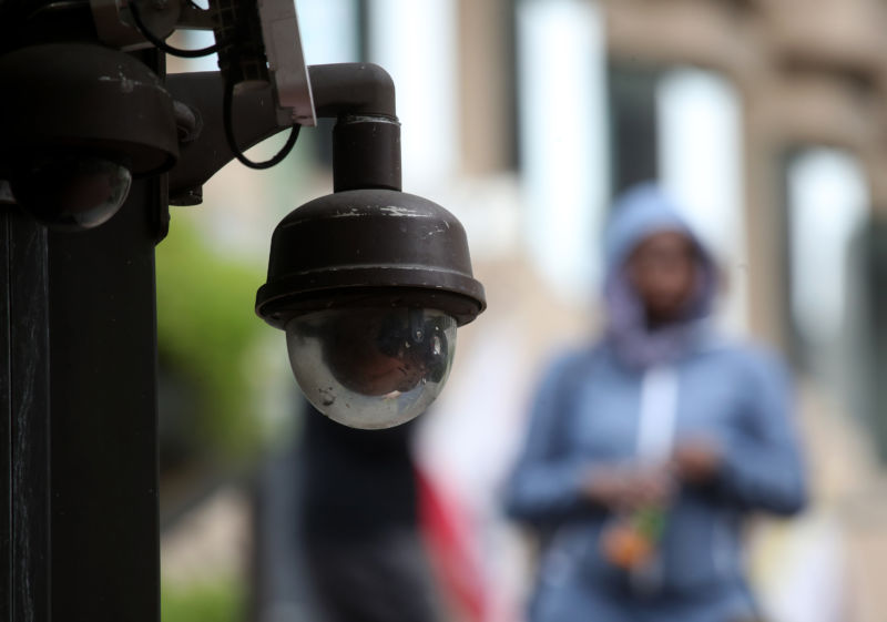 A video surveillance camera hangs from the side of a building on May 14, 2019, in San Francisco, California. 