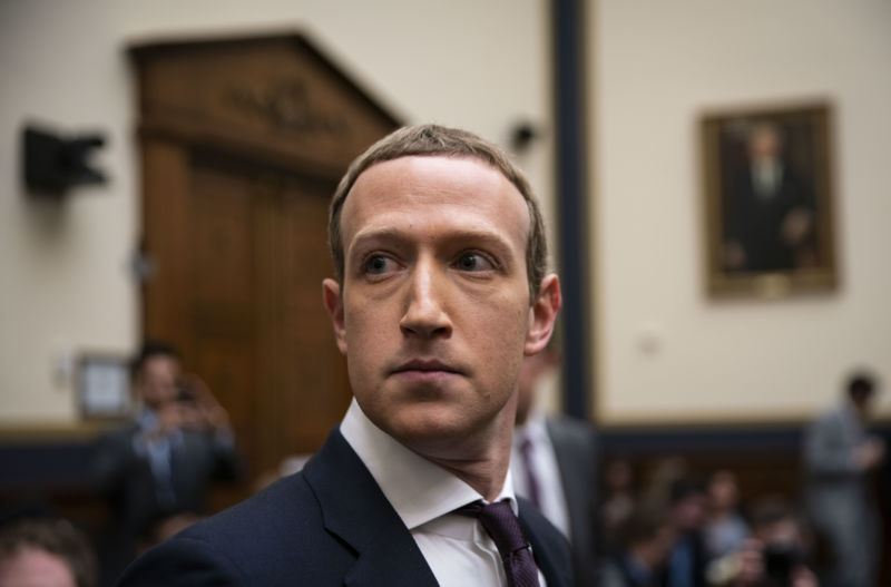 A man in a suit looks nervously around a courtroom.