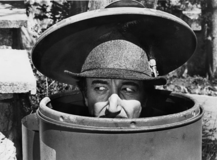 Peter Sellers as Inspector Clouseau is disguised as a mountain climber, while hiding in  a trash can, in a scene from the film 'The Pink Panther Strikes Again', 1976. (Photo by United Artists/Getty Images)