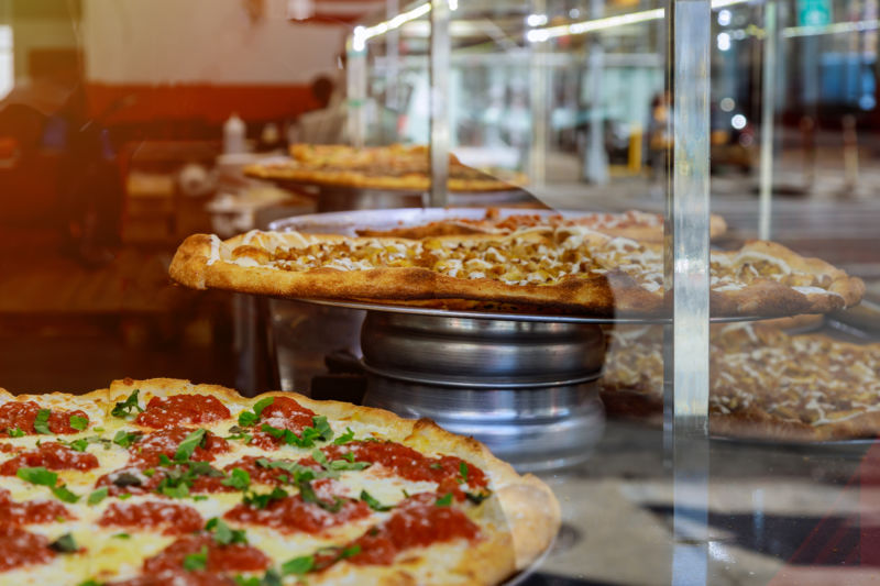 Pizza on display at a restaurant.