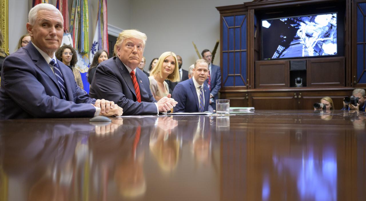 President Donald Trump, joined by Vice President Mike Pence, left, Ivanka Trump, and NASA Administrator Jim Bridenstine, right, speaks with NASA astronauts Christina Koch and Jessica Meir during the first all-woman spacewalk on Friday from the Roosevelt Room of the White House.