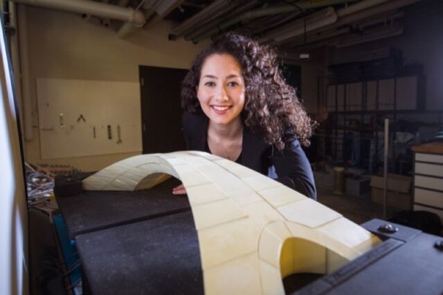 MIT graduate student Karly Bast with a model of Leonardo da Vinci's bridge.