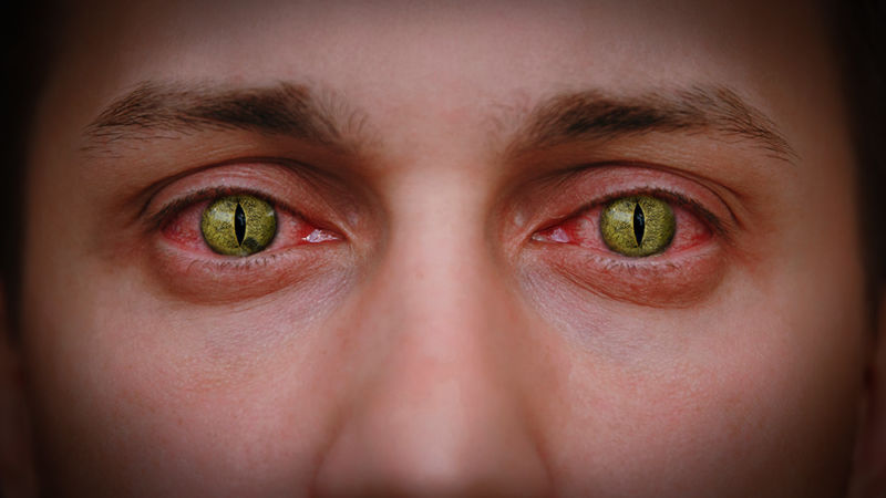 Closeup image of man wearing scary contact lenses.